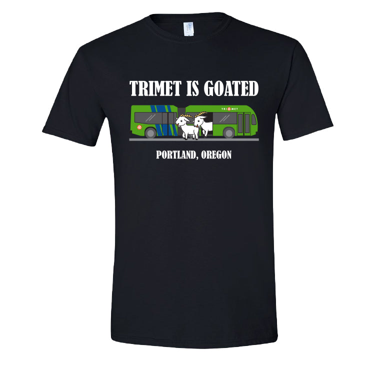 Black T-shirt featuring large white text reading "TRIMET IS GOATED" above an illustration of a green TriMet FX articulated bus. Two white goats are stepping out from the center doors of the bus. White text at the bottom reads “Portland, Oregon.”